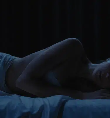 Evolova big ass sex doll with a teal-blue body lying on her side, showcasing voluptuous curves and a lifelike sculpted booty.